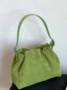 Green faux suede bucket bag with adjustable strap and textured finish for women