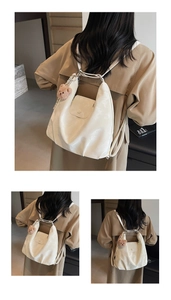Detail of white pleated tote bag showing soft texture and brown teddy bear charm