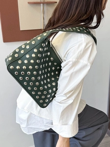 Retro dark green leather shoulder bag with silver studs and a punk chic style