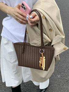 Vintage brown woven tote bag with wooden bead charm and long shoulder straps for women