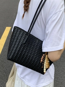 Retro black woven tote bag with ethnic wood bead tassel on thin double shoulder straps