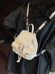 Creamy white mini leather backpack with a bow and drawstring closure for women