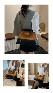 Detail of a large tote bag featuring brown suede and black quilted leather with gold chain