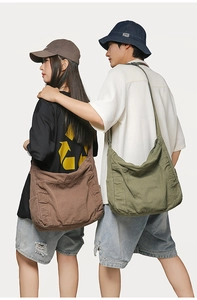 Detail view of large canvas tote bags in coffee and olive green colors with side pockets
