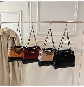 Close-up of four quilted chain bags in yellow, burgundy, khaki, and black on a rack