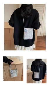 Détails de la broderie papillon bleu et texture en mesh sur le mini sac bandoulière