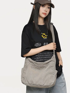 Gray canvas messenger bag with large pockets and adjustable strap for women