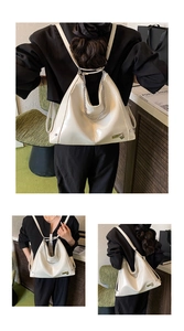 Detail of cream white faux leather tote featuring silver chain and heart charm