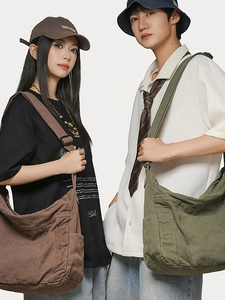 Large canvas shoulder bag in brown and army green with wide straps and utility pockets