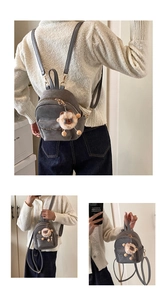 Detail of grey mini backpack in faux suede with gold hardware and lion plush keychain