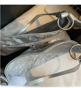 Detail of silver metallic tote bag with high-quality smooth metal zipper and inner lining