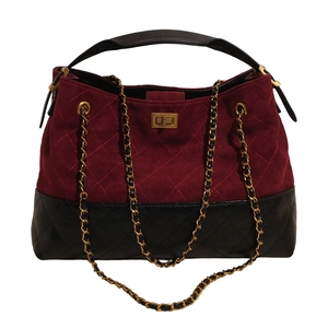 Quilted tote bag with burgundy suede and black leather panels featuring a gold chain strap