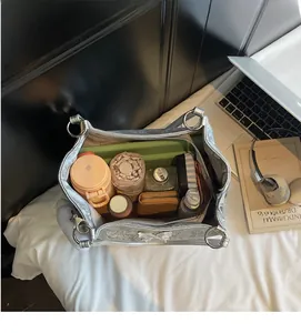 Top view showing the spacious interior of a silver tote bag with various daily essentials
