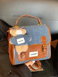Denim patchwork backpack with brown leather trim and cute plush bear accessory