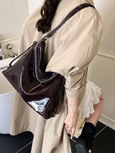 Glossy dark brown leather hobo bag with silver chain and adjustable shoulder strap