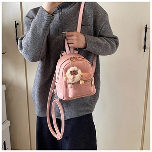 Pink mini backpack detail showing soft matte fabric texture and cute lion plush charm