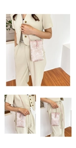 Detail of pink floral brocade phone bag with pearl button closure and slim shoulder strap