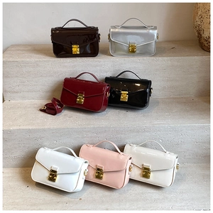 Detailed display of patent leather crossbody bags in seven colors with gold buckles