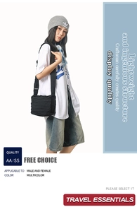 Detail of black pleated crossbody bag with wide strap in Japanese street fashion style