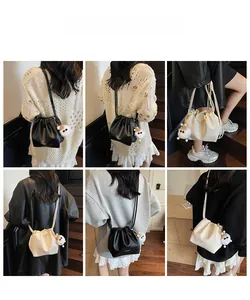 Collage of pleated drawstring bucket bags in black and beige with plush ball pendant