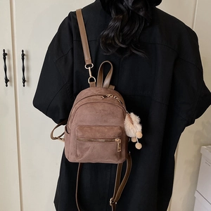 Chic brown suede mini backpack with golden hardware and plush pompom for women