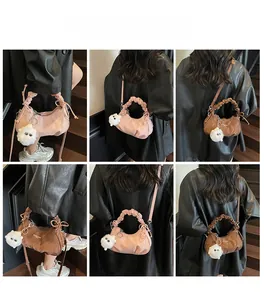 Mannequin portant un sac croissant plissé rose et marron avec breloque peluche