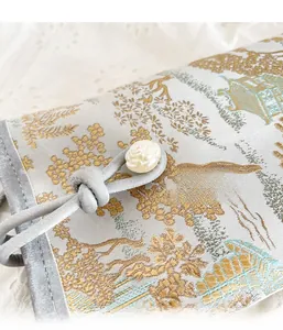 Detail of Chinese style jacquard fabric bag with rose button and gold thread pattern