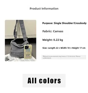 Grey canvas crossbody bag dimensions 22x10x17cm with raw edge vintage design details