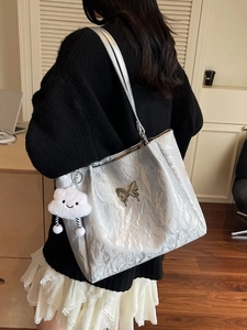 Silver pleated tote bag with metal butterfly and cloud charm for daily commuting