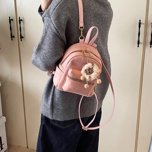 Pink mini backpack in suede texture with a cute brown plush animal keychain for women