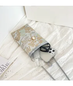 Detail view of jacquard crossbody bag showing internal capacity for phone and accessories