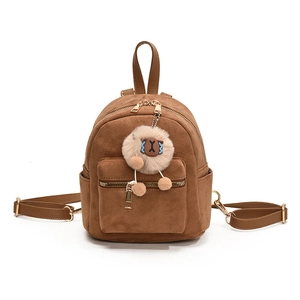 Brown faux suede mini backpack with a beige plush sheep charm on white background