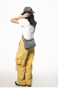 Detail of grey distressed canvas crossbody bag with horizontal washed frayed edges