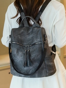 Women's vintage PU leather backpack in dark grey with stylish dual tassels and side pockets