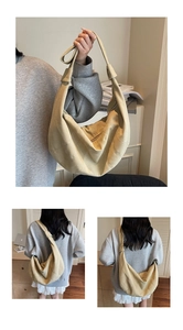 Detail of light khaki crescent tote bag showing multi-panel stitching and knotted strap