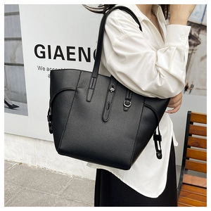 Close-up of black lychee grain tote bag with silver D-ring and slender shoulder straps