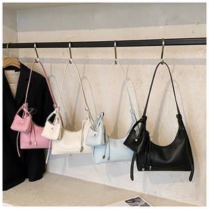 Detailed display of minimalist crescent hobo bags in multiple colors with matching charms