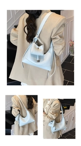 Detail of light blue hobo bag set with matching coin purse on wide shoulder strap