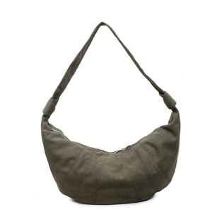Minimalist dark green croissant shoulder bag with stitched panels and knotted strap