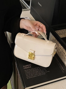 Elegant cream patent leather crossbody bag with gold buckle and chain strap for women
