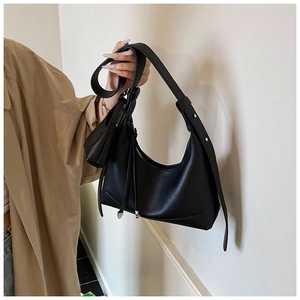 Detail of black lychee grain leather hobo bag with mini coin purse and silver rivets