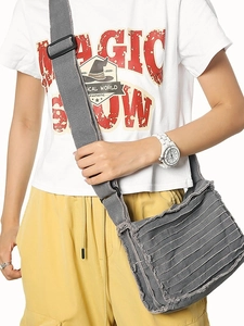 Grey canvas crossbody bag with layered fringe texture and adjustable shoulder strap for women