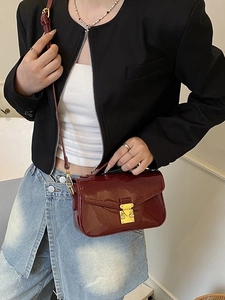 Deep red glossy patent leather chain shoulder bag with a gold metal push lock closure