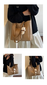 Detail of light brown tote bag featuring fine woven texture and a cute plush bear charm