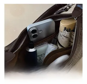 Detailed interior view of dark brown woven bucket bag showing spacious storage capacity