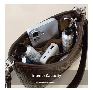 Top view of woven bucket bag interior showing phone and cosmetics for capacity