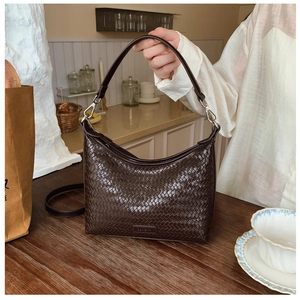 Detail of dark brown woven texture PU leather hobo bag with adjustable shoulder strap