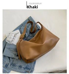 Detail of khaki hobo shoulder bag with wide strap and adjustable golden metal buckle