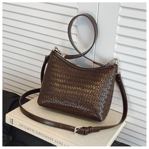 Detail of brown woven bucket bag featuring premium PU texture and silver hardware accents