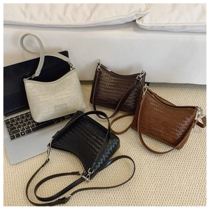 Detail view of woven leather bucket bags in white, coffee, tan and black colors